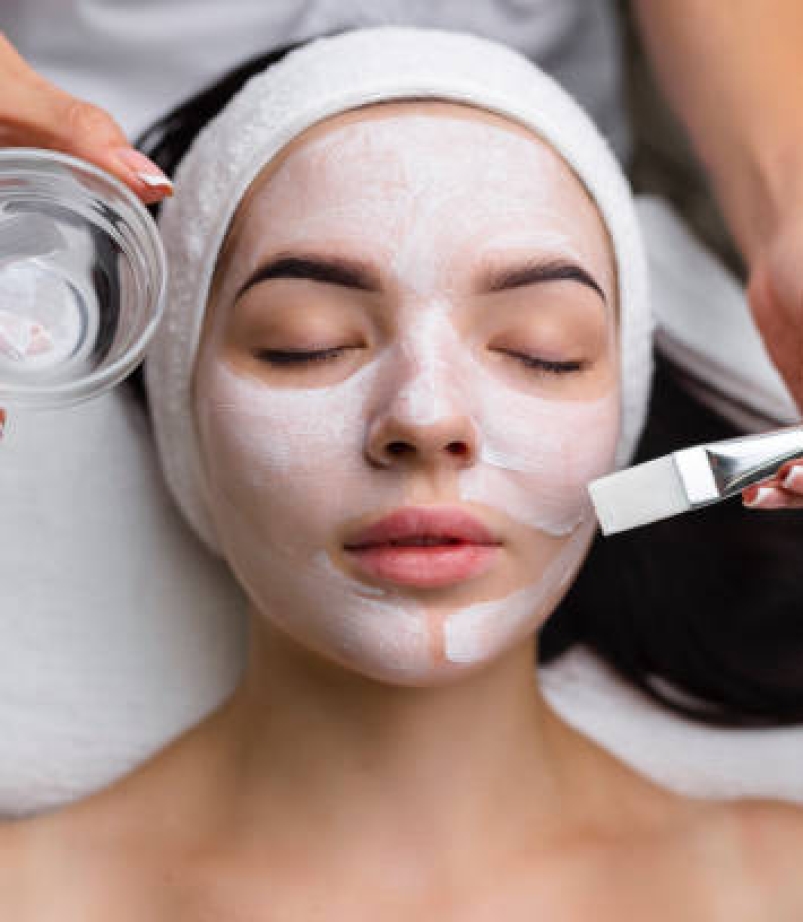 Close-up shot of a woman getting facial treatment with clay mask. Cosmetology and spa. High quality 4k footage